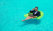 man trader work and relax. man trader work and relax in swimming pool. man trader work and relax with laptop