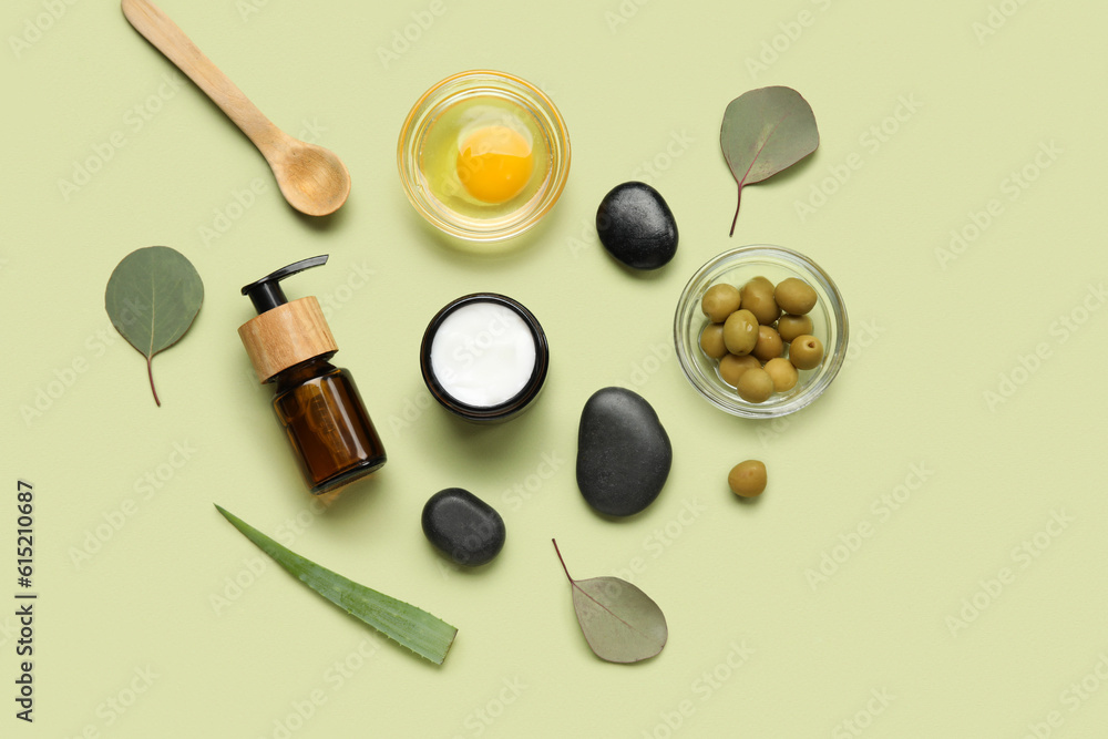 Composition with natural cosmetics, ingredients and spa stones on color background