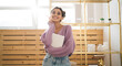 © BullRun - Gentle sweet girl in purple sweater posing at camera smiling sincerely from. Radiant brunette woman with beautiful appearance holds diary in hands. Positive female student with notebook organizer