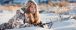 © Michal - A beautiful young hunter woman in camouflage lies on the ground and looks into the rifle. generative ai