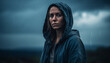 © Stockgiu - A young adult in a hooded shirt stands alone in rain generated by AI