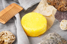 Yellow Handmade Solid Shampoo, Hair Comb And Stones On Table, Closeup