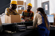 © DC Studio - Warehouse workers holding parcel at reception, discussing package transportation. Freight distribution manager receiving cardboard box ready for shipment at checkout desk