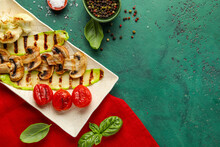 Plate With Grilled Vegetables And Basil On Green Background
