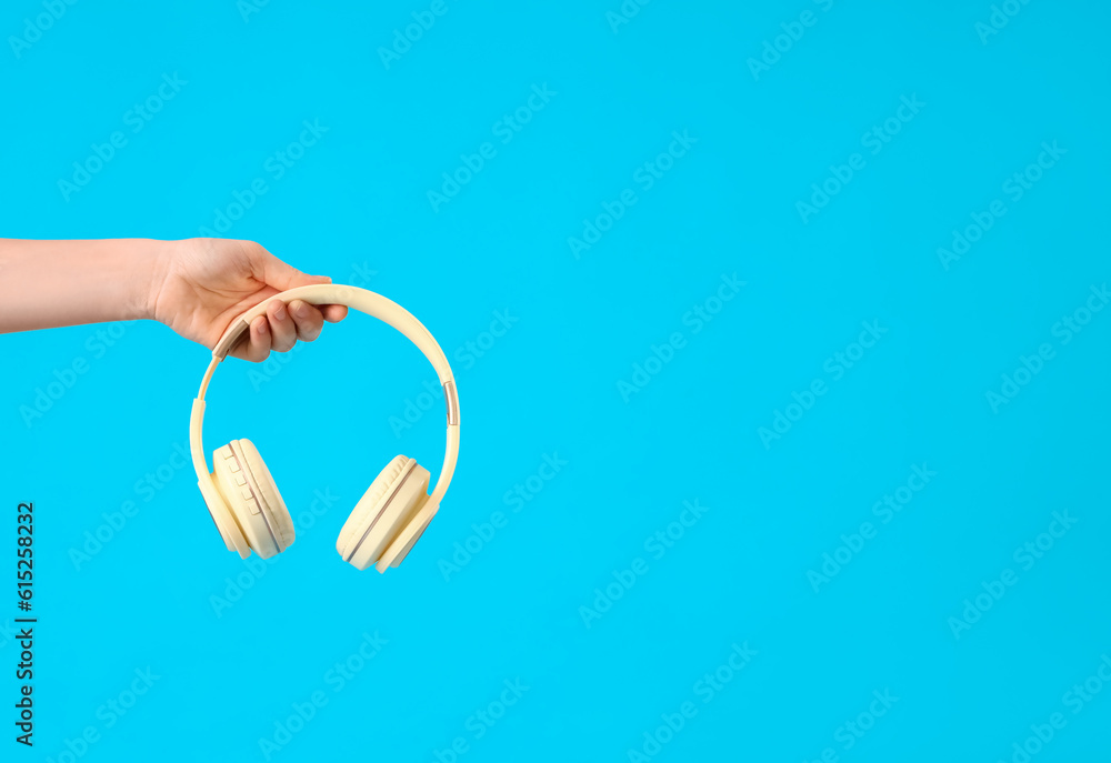 Woman with headphones on blue background