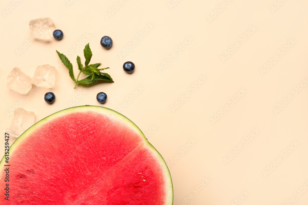 Half of fresh watermelon and blueberries on orange background