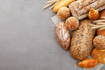 top view different kinds of fresh bread on the food slate.