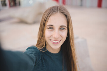 young blonde teenage girl student wears casual clothes take selfie with smartphone. high school coll