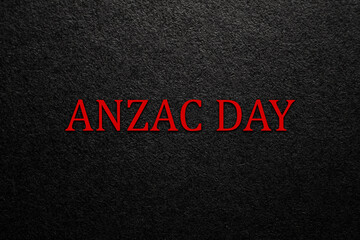 Wall Mural - Text Anzac Day on black textured background. Anzac Day in New Zealand, Australia, Canada and Great Britain. Banner.