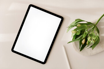 Blank screen tablet mock up with pen drawing and sketching on white office desk. 