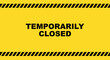 Temporarily closed sign on yellow background