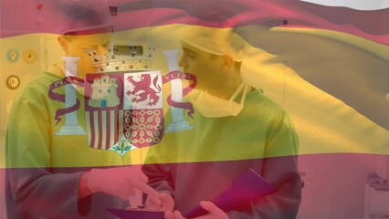 Sticker - Animation of spain flag waving over diverse surgeons discussing patients reports in hospital