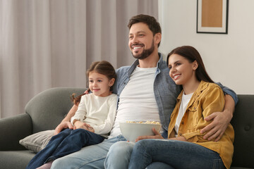 Canvas Print - Happy family watching TV on sofa at home