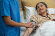 © Jirakul - Doctor and nurse measuring blood pressure of patient in recovery room after treatment