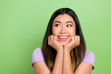 Wall Mural - Photo of pretty vietnamese chinese young girl look empty space admire dressed stylish violet outfit isolated on green color background