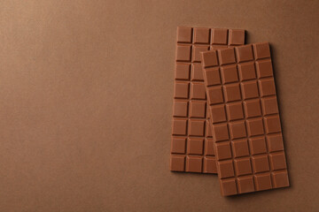 Wall Mural - tasty chocolate bars on brown background, flat lay. space for text