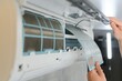 © Serhii - Service man is cleaning, repair and maintenance of air conditioner.