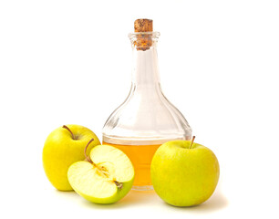 Wall Mural - A decanter with apple cider vinegar, two and half apples isolated on white background.