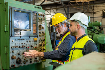 Wall Mural - Two professional engineer worker technician assistant in helmet inspection check old machine construction factory with colleague manager. check old machinery production construction operating