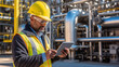 Portrait of refinery worker using tablet and checking oil and gas product quality.