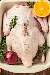 Wall Mural - Fresh raw whole duck ready for cooking on a wooden background, Culinary cooking. banner, menu, recipe place for text, top view