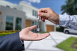 © Oleksandr - Handing Over The New House Keys with Home in the Background.