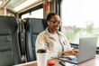 © Jelena Stanojkovic - Young business woman traveling to work by train, working while traveling, with her laptop and smartphone during the day.