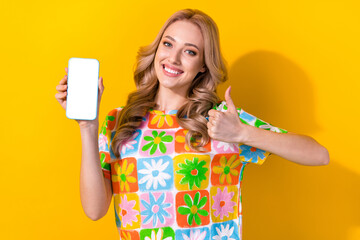 Sticker - Photo of adorable nice girl dressed colorful t-shirt demonstrate touchscreen smartphone show thumb up isolated on yellow color background