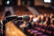 © Tisha - A microphone in front of a conference seminar audience