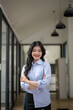 © Wasana - portrait of beautiful asian business woman confident standing in office.