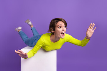 Sticker - Full body cadre photo of funny young woman flying careless overjoyed entertainment on podium isolated over violet color background