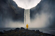 © ADDICTIVE STOCK - Anonymous person contemplating a waterfall in Iceland. Generative AI