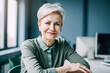 © ximich_natali - Beautiful middle-aged financial business woman executive, with gray hair in a green blouse, looks at the camera and smiles