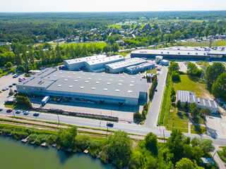 Aerial view of distribution center, drone photo of industrial logistics zone,new super modern logistics center full of modern technology and robotics,roof solar power plant for green energy production