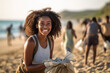 © Nedrofly - A woman holding a bag of garbage on a beach