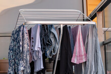 Clothes Drying On A Drying Rack On A Balcony In The Sun.