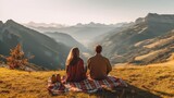 Young couple in love doing picnic visiting alps Dolomities. Boyfriend and girlfriend sitting and looking at the beautiful scenic green meadow landscape.