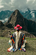 Tourist photography in Machu Picchu. Traveler with poncho and Inca hat. Wonder of the World. Colors	
