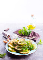 Wall Mural - fried squash with oil and garlic on blue plate