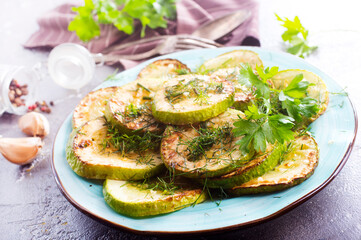 Wall Mural - fried squash with oil and garlic on blue plate