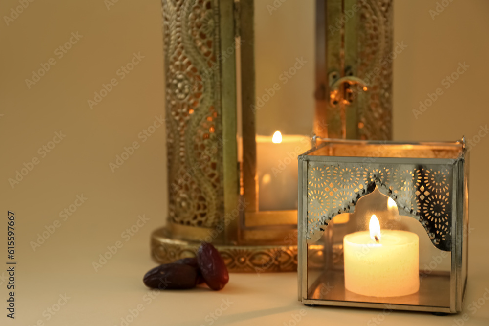 Muslim lamps with burning candles and dates on color background