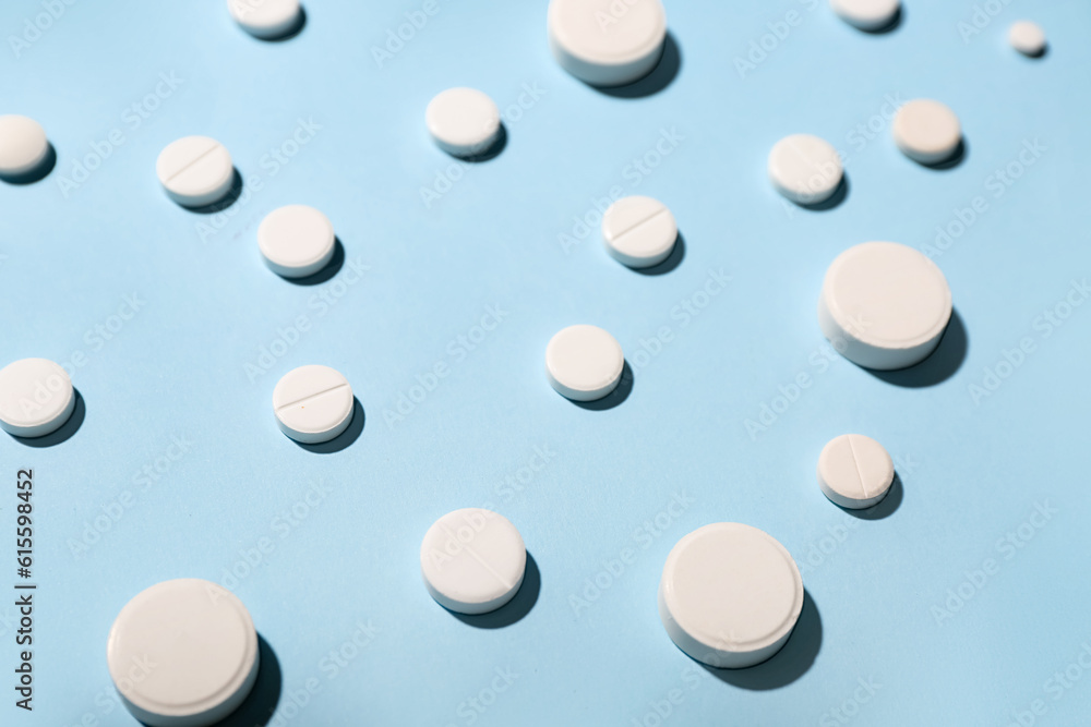 White pills on blue background