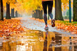 Legs of a female runner jogging in a park on an autumn afternoon