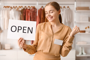 Canvas Print - Female seller with opening sign in boutique