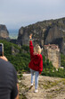 tourist in greece with the meteora monasteries in the background