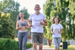 © zinkevych - Mature friends running together outdoor, jogging.
