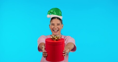 Sticker - Holiday face, Christmas and a woman with a gift for happiness isolated on blue background in a studio. Happy, party and portrait of a girl giving gift for celebration or birthday with a festive box