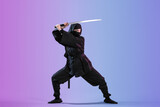 Female ninja with sword on color background