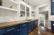 home kitchen with navy blue accents and white tile 