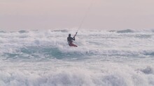 Kite Surfer On Rough Ocean Going Against Smaller Waves